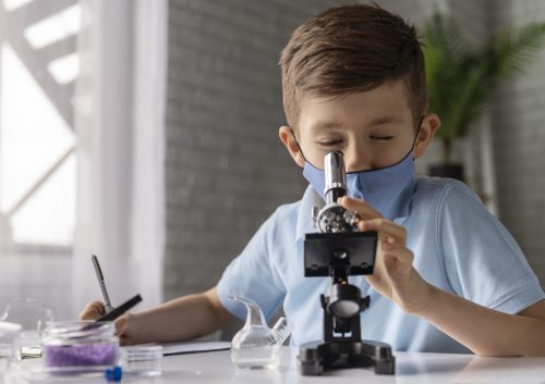 medium shot kid looking through microscope scaled